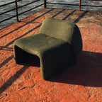 Furrow Chair in olive corduroy, armless, with closed sides that carry down to the floor.