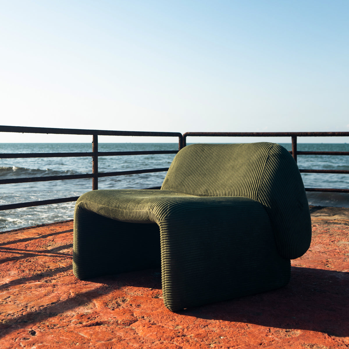 Furrow Chair seen from the front at a distance, showing the full outline of the chair.