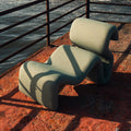 Swale Chair in sage bouclé, seen from the front, made as one continuous sweep with no arms and no legs.